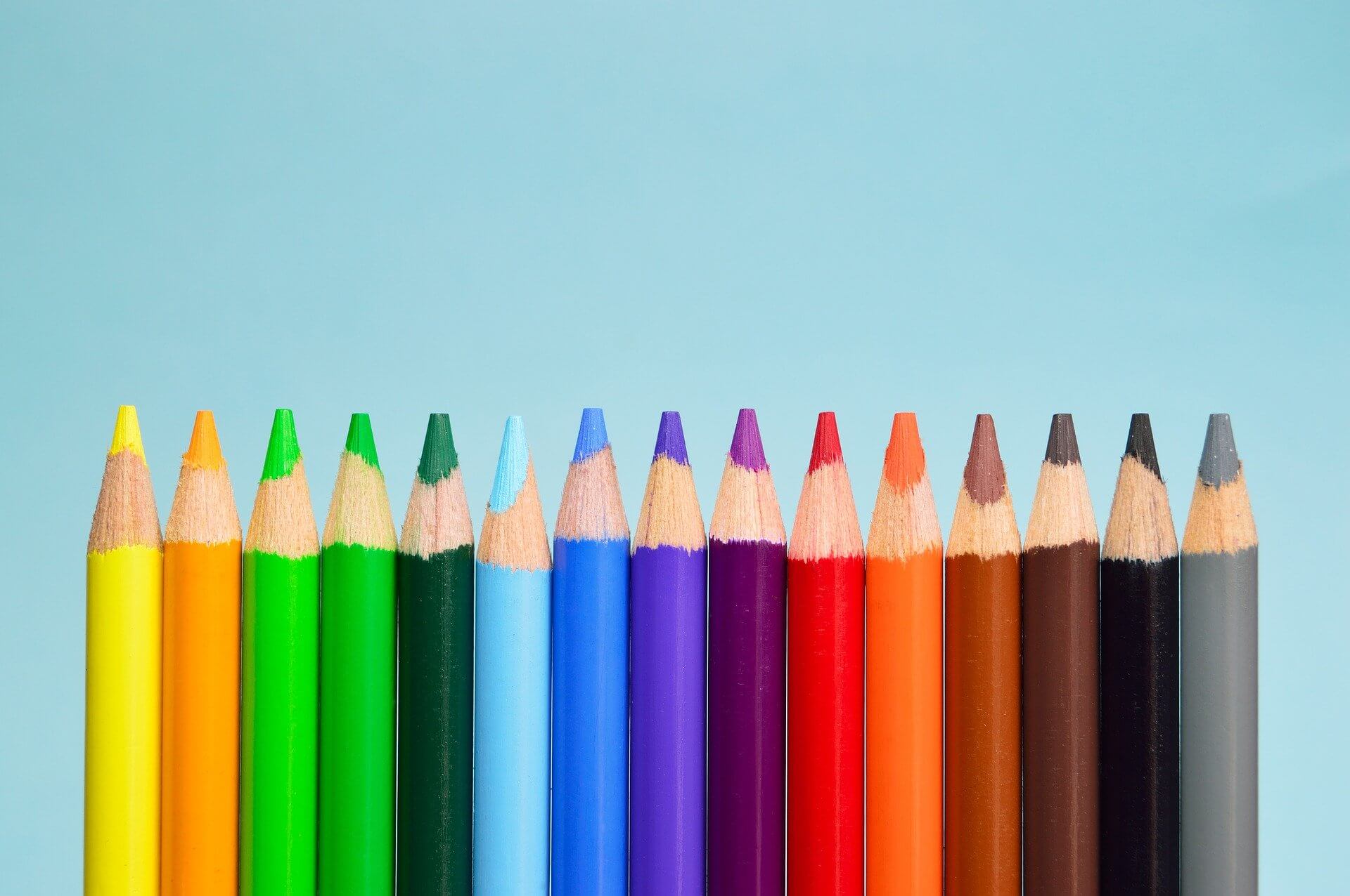 Coloured-pencils-on-a-blue-background-image-for-blog-feature