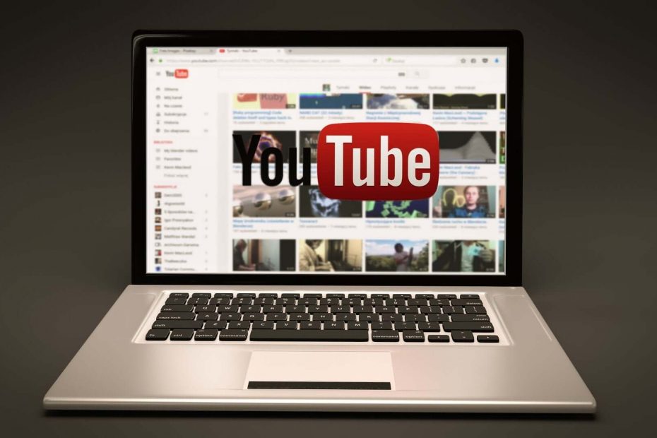 The YouTube website homepage on a laptop, with the logo overlaid on top